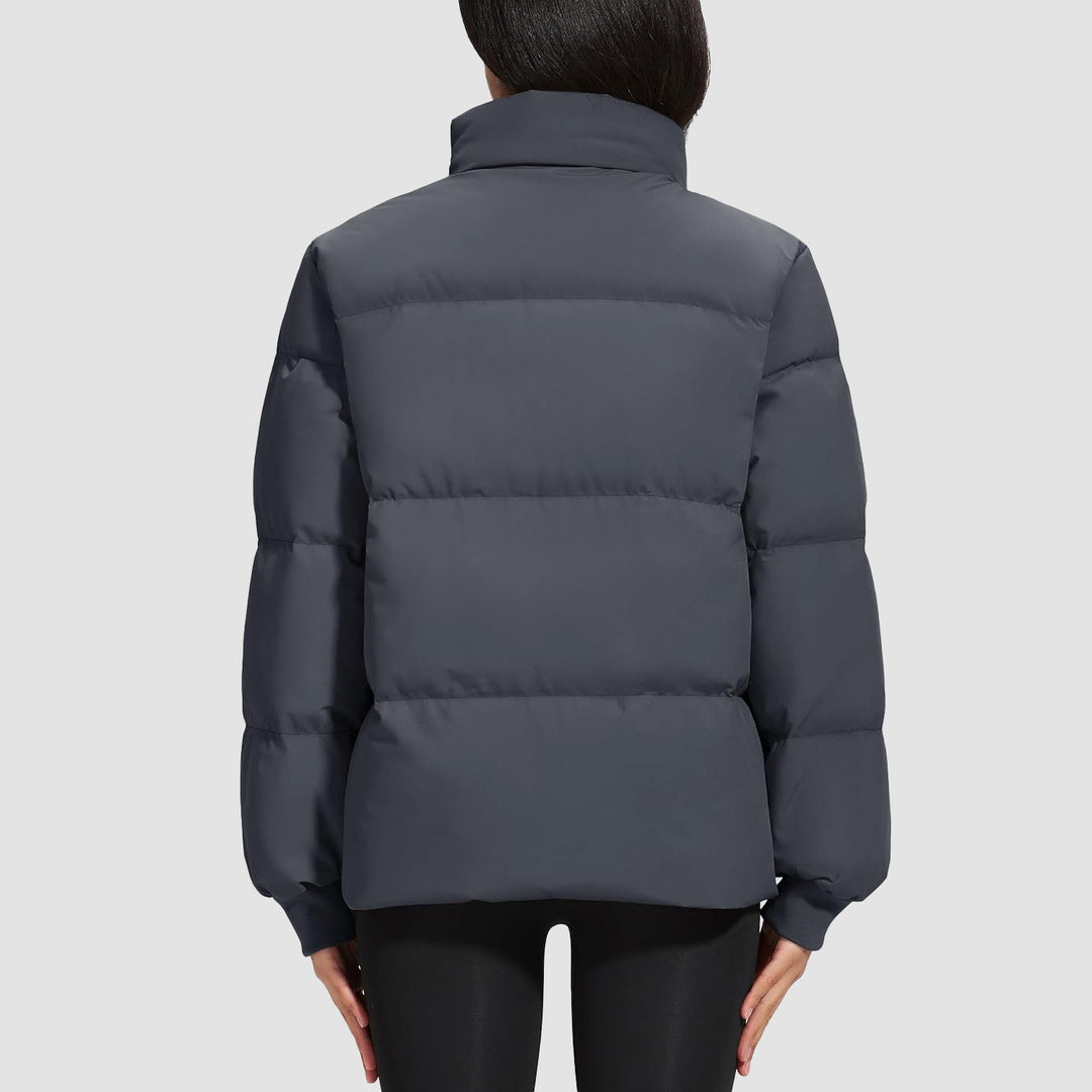 Black women's down puffer jacket, showing its compressibility and warmth for travel