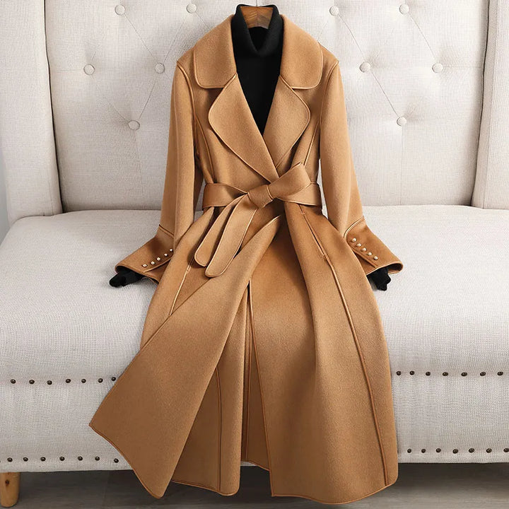 Women's long trench coat with belted waist, tailored fit. Classic style for elegant outerwear in fall & spring.