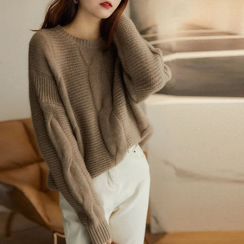 Close-up of a women's cashmere blend cable knit pullover, highlighting the intricate texture and soft feel