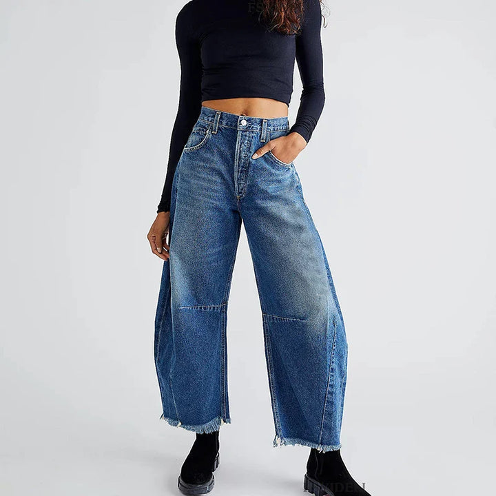 Women's organic loose fit high-rise jeans with straight leg and frayed hem, Sustainable fashion denim.