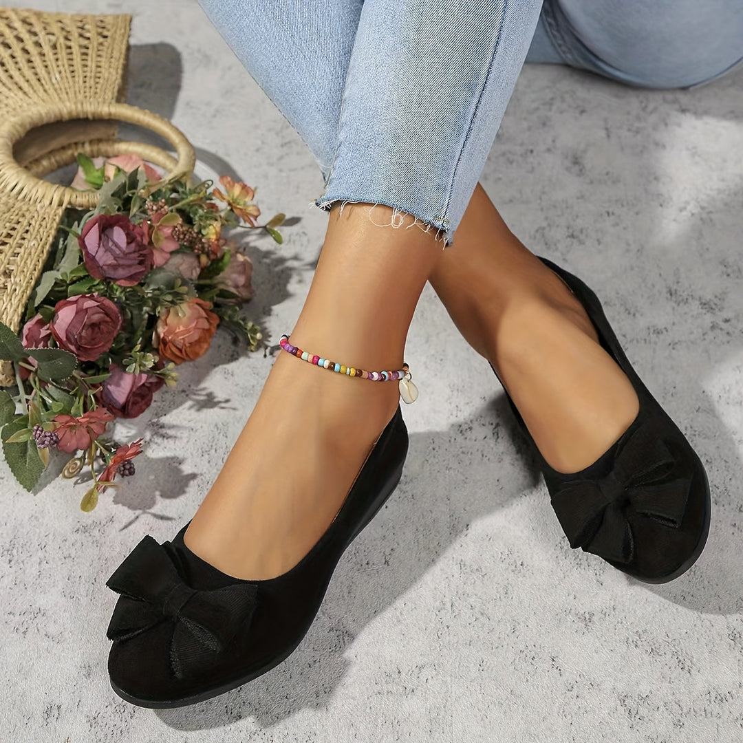 Front view of women's orthopedic flats, showcasing slip-on design & bow detail.