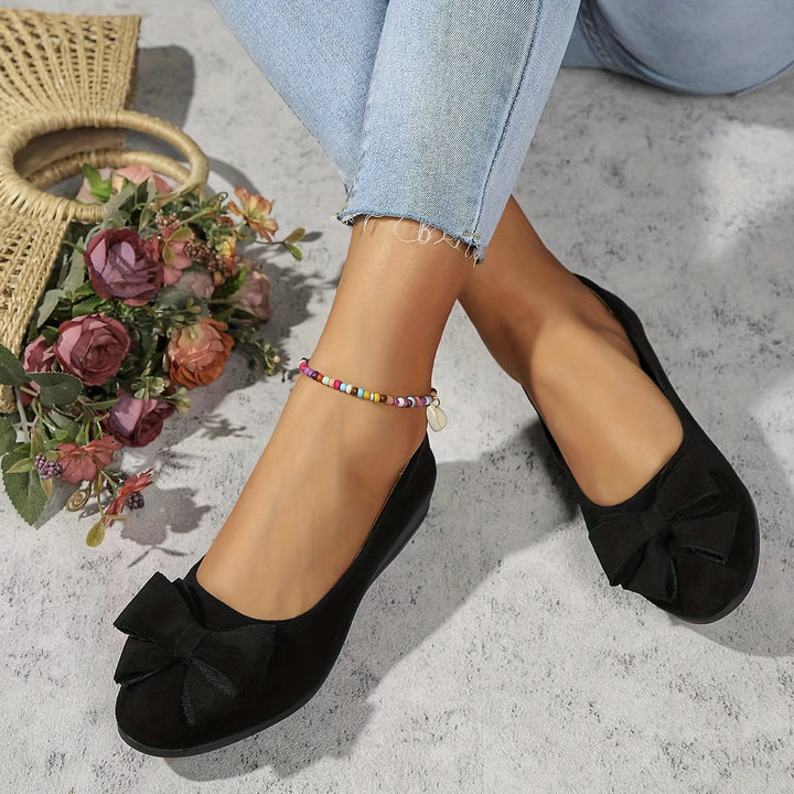 Front view of women's orthopedic flats, showcasing slip-on design & bow detail.
