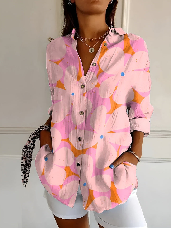 Detailed view of women's floral vine print oversized blouse fabric. Button down long sleeve top for women.