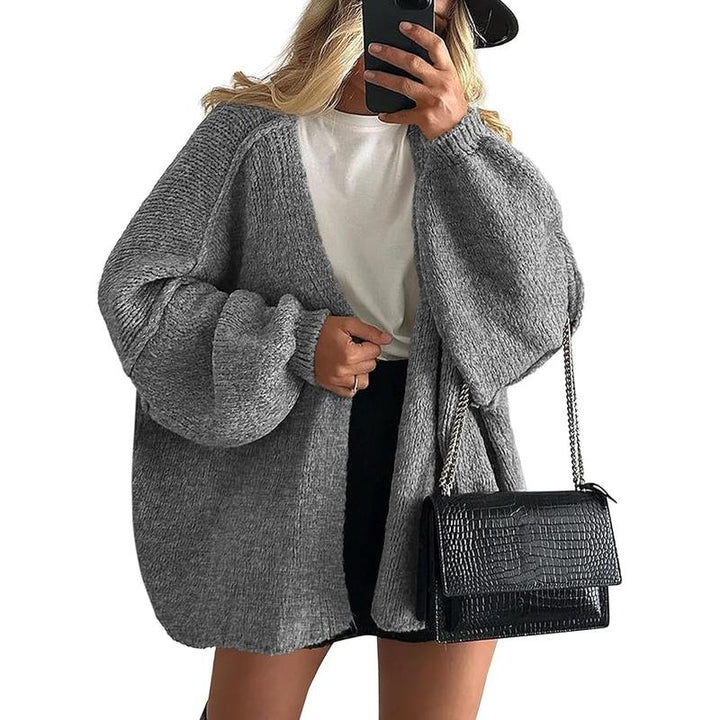 Stylish women's oversized knit cardigan with an open front, ideal for layering and winter warmth.