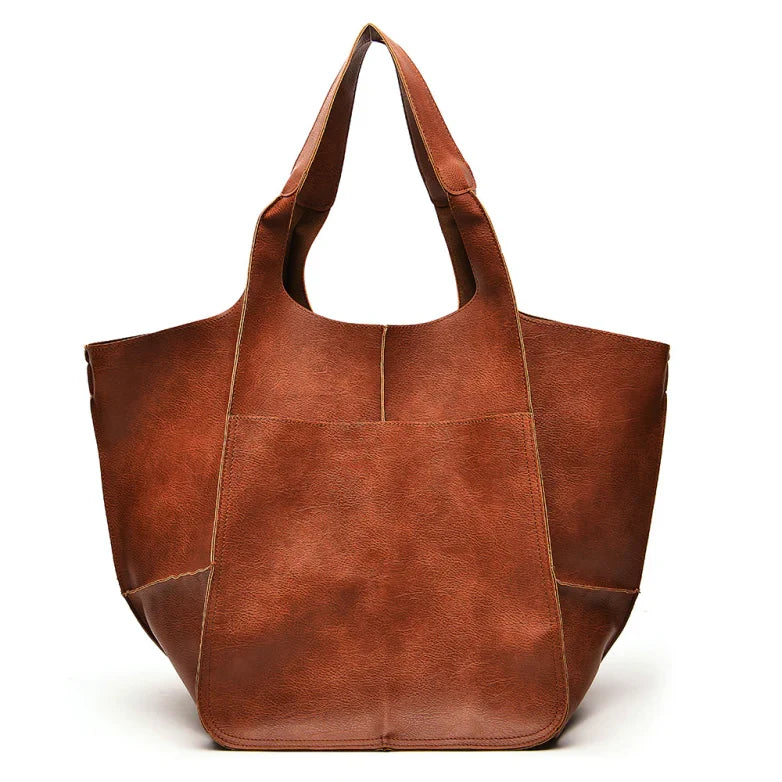 Women's fashion statement: oversized vintage leather shoulder bag, a must-have accessory.
