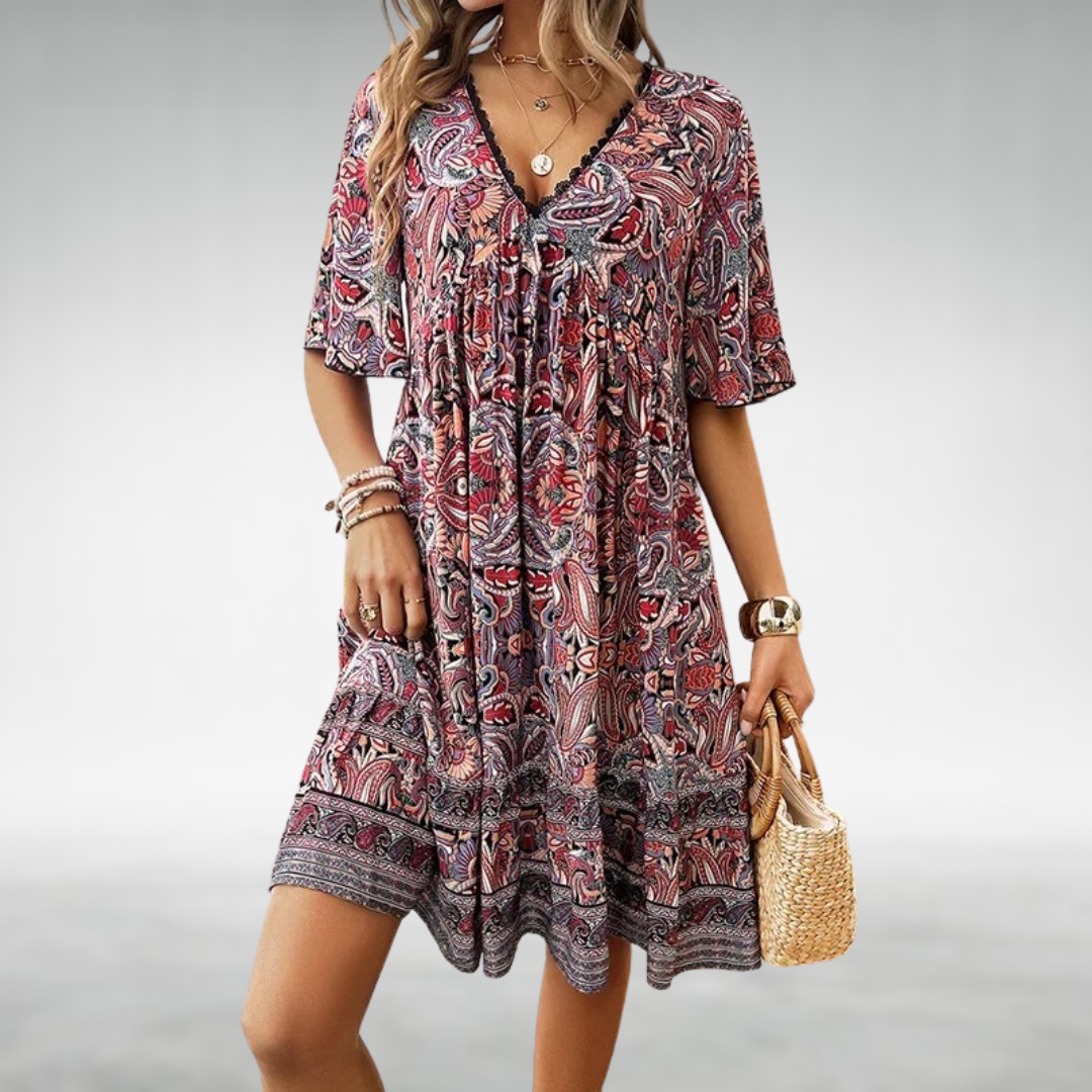 Casual women's short ruffle dress with a vibrant paisley print, lace trim, and V-neckline.