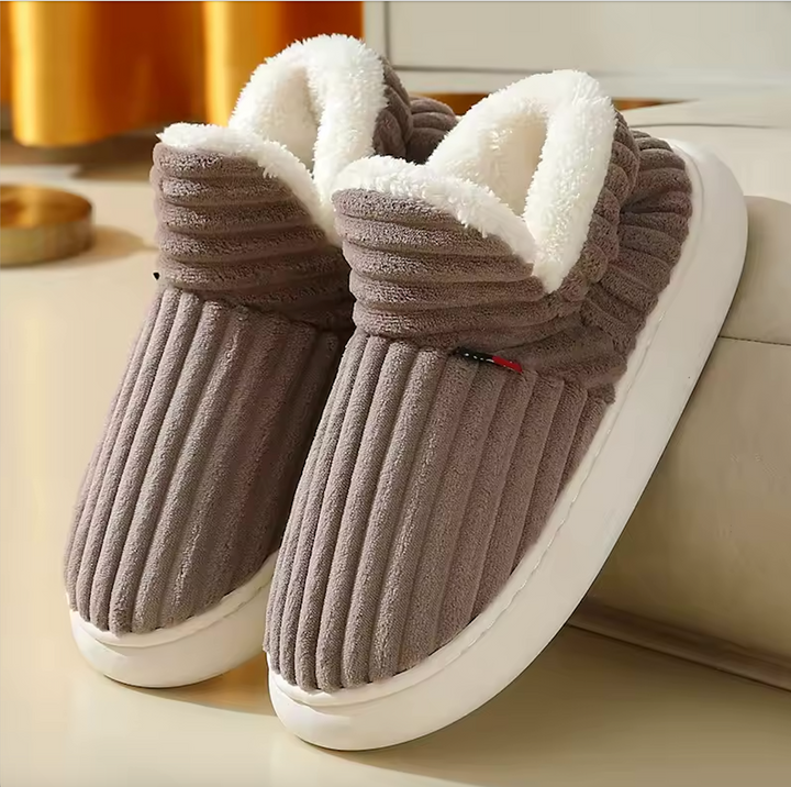 Pair of women's memory foam slippers, plush fleece lined for ultimate warmth and comfort
