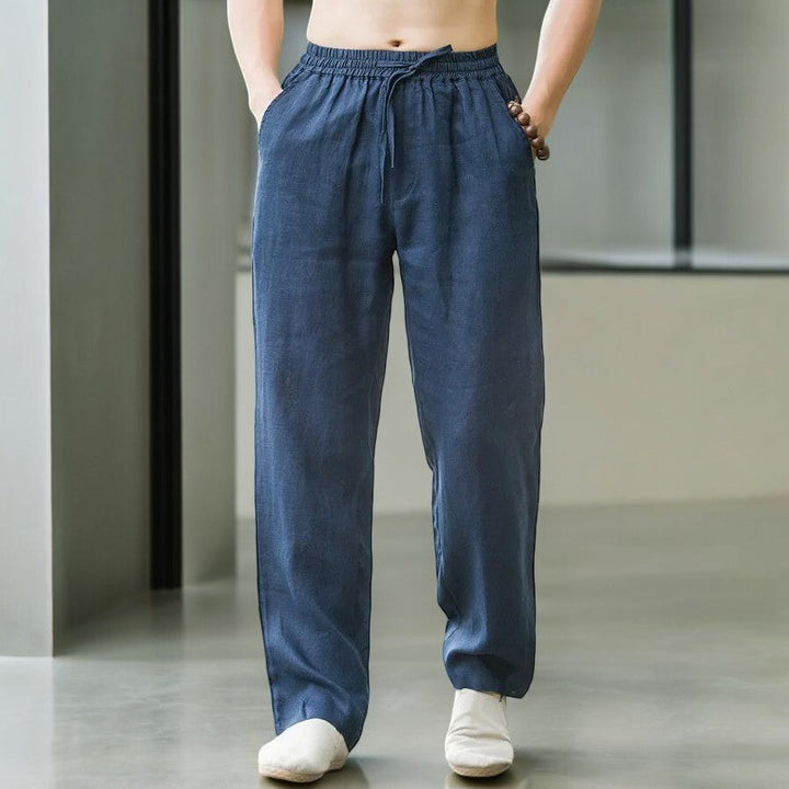 Woman sitting cross-legged wearing relaxed fit linen pants, emphasizing comfort and flexibility