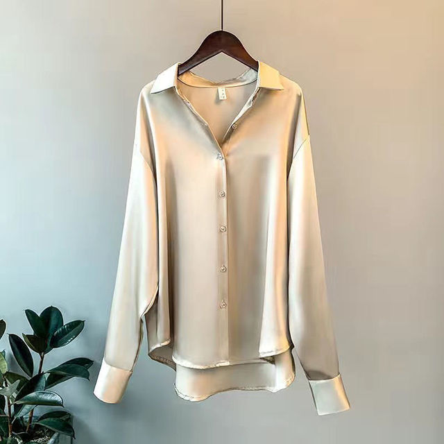 Fashionable women's satin button-down blouse, relaxed fit, offering a chic and versatile look.
