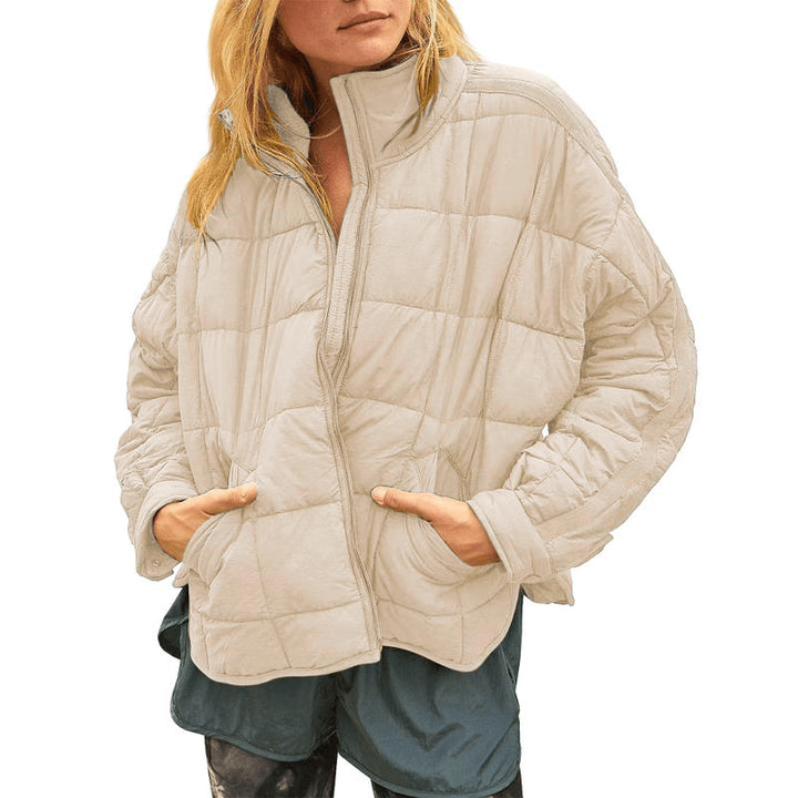 Full-body shot of a woman wearing a relaxed fit quilted puffer jacket, showcasing its comfortable style.