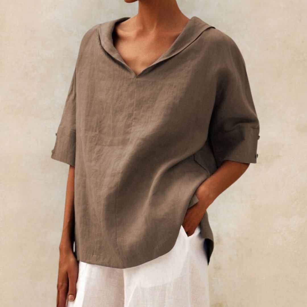 Stylish women's long-sleeve V-neck top in a vibrant blue, great for relaxed spring outfits
