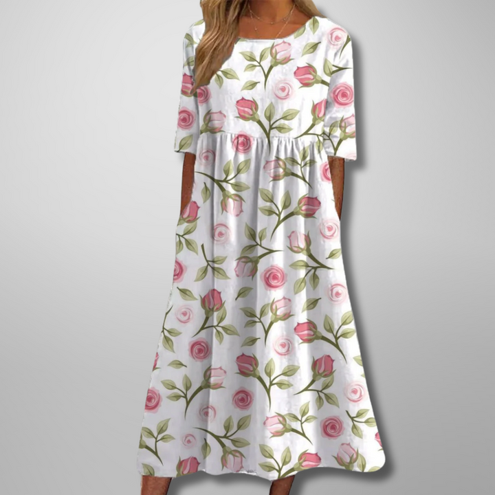 Woman wearing a relaxed fit floral midi dress, embodying effortless style for spring/summer.