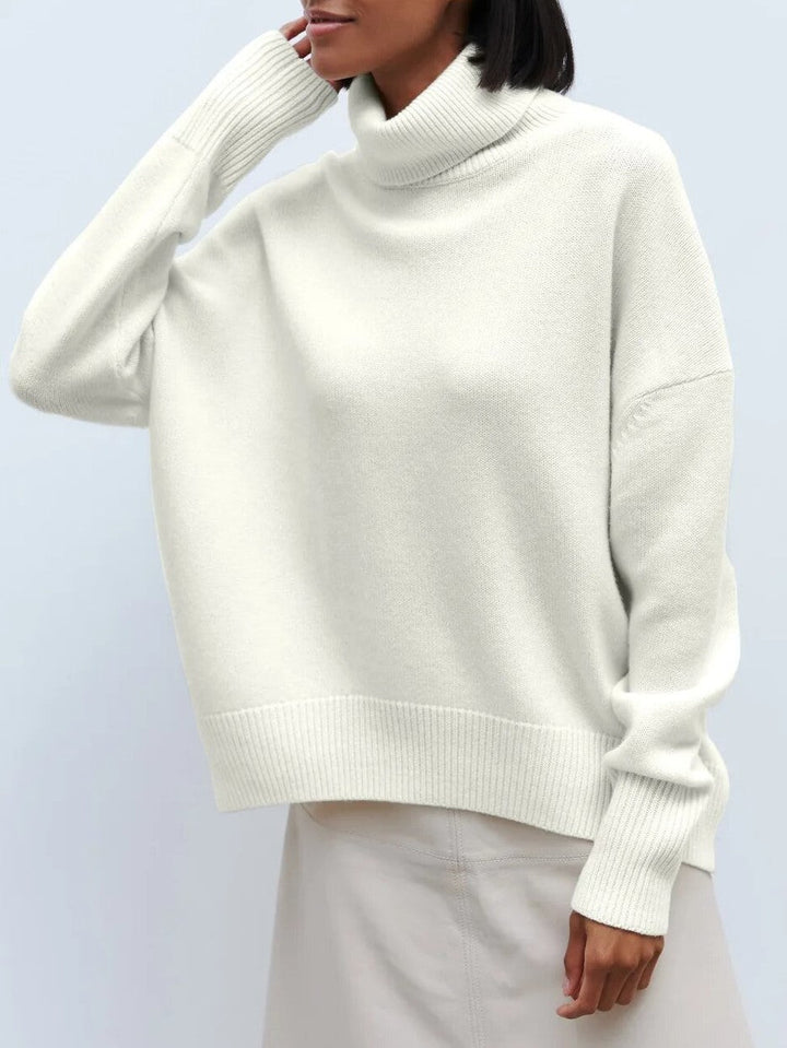 Cozy knit women's turtleneck sweater in merino blend, an essential long sleeve top for winter fashion.