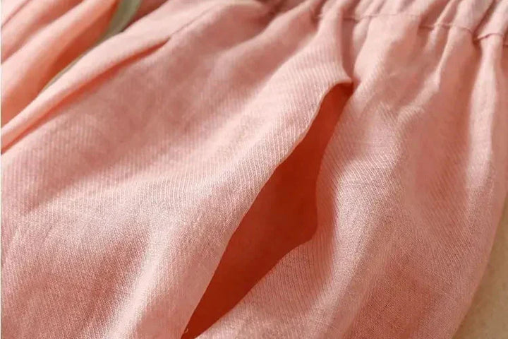 Back view of women's relaxed tapered linen trousers, showing the flattering and comfortable fit.