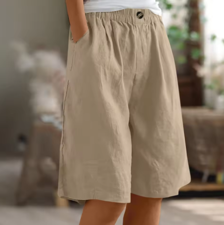 Close-up of the fabric texture and elastic waistband on women's relaxed wide leg Bermuda shorts.