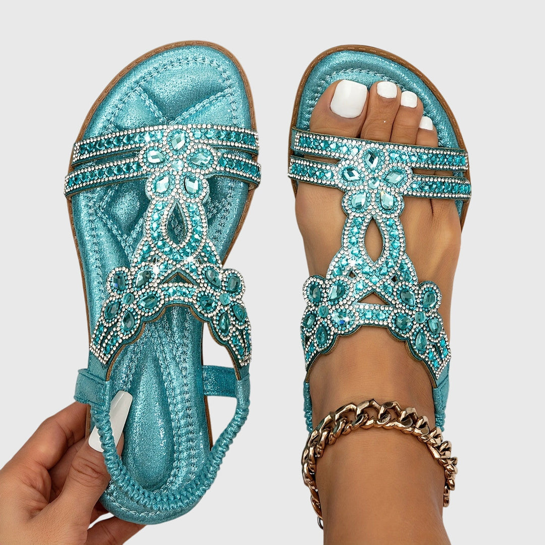 Glamorous women's flat sandals with intricate rhinestone details, perfect for any occasion.