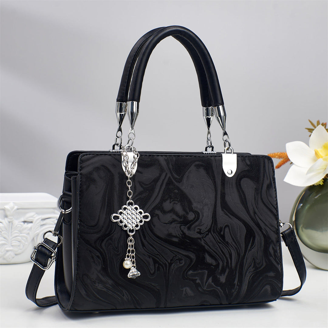 Elegant women's square crossbody bag with a minimalist aesthetic and a trendy chain shoulder strap