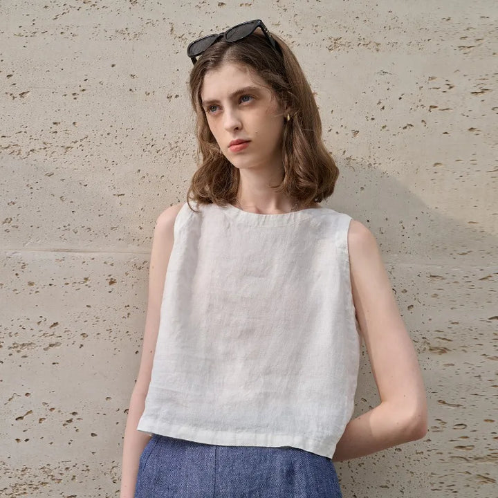 Fashionable women's sleeveless asymmetric crop top, crew neck. Embrace modern, relaxed summer looks.