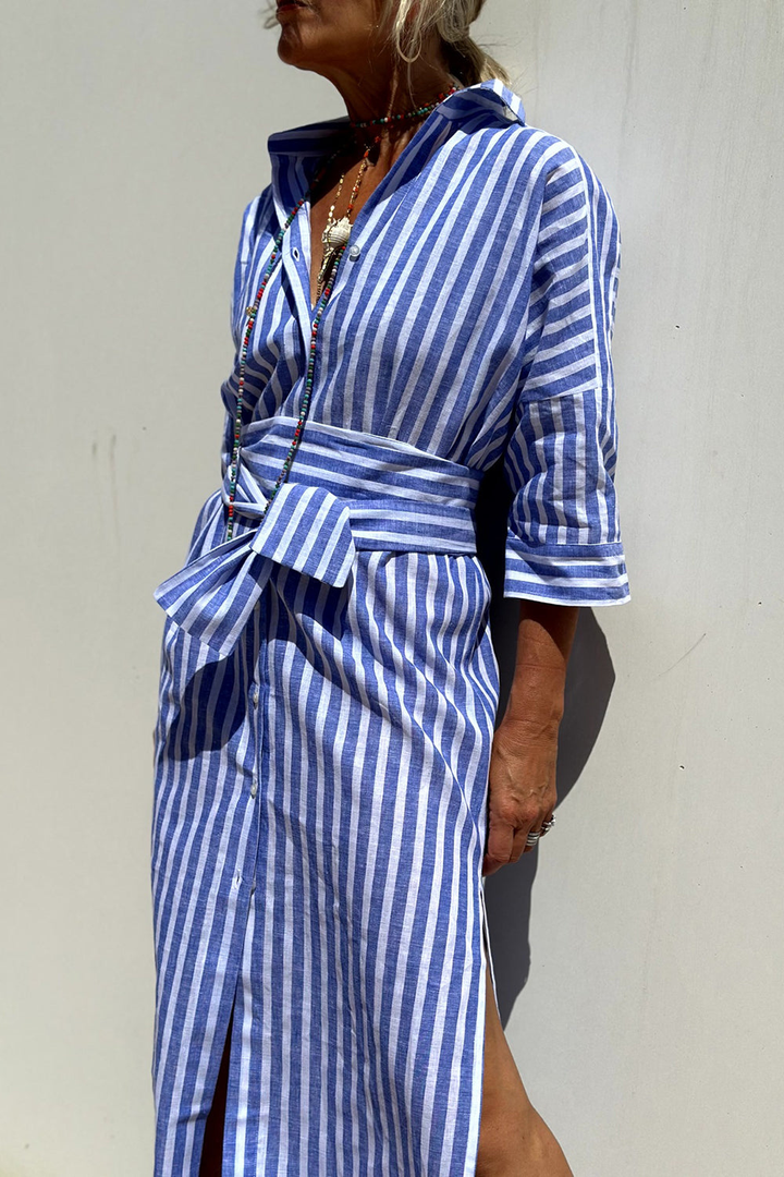 Close-up of the striped pattern on a women's oversized button-down collared midi dress, highlighting fabric.