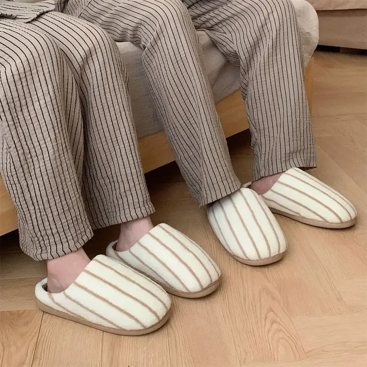 Close-up of women's striped fleece slippers, featuring plush lining and cozy design