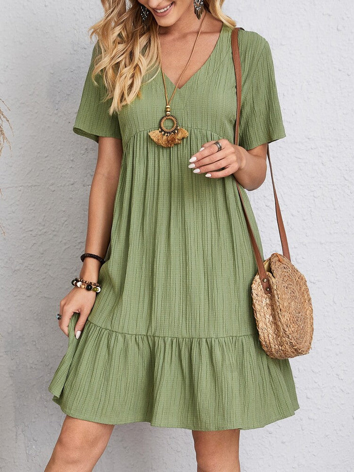 Versatile V-neck tiered mini dress for women, short sleeve. Ideal casual summer wear, comfortable & chic.
