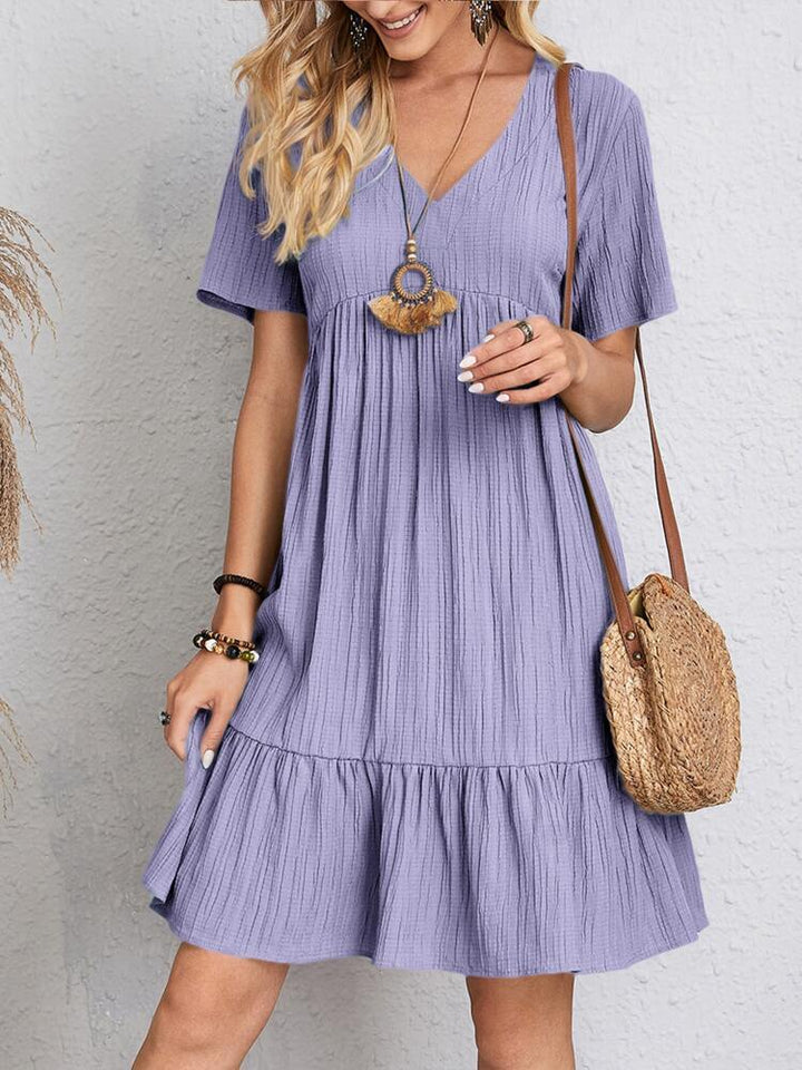 Chic women's V-neck tiered mini dress with short sleeves. A comfortable casual summer dress for any occasion.