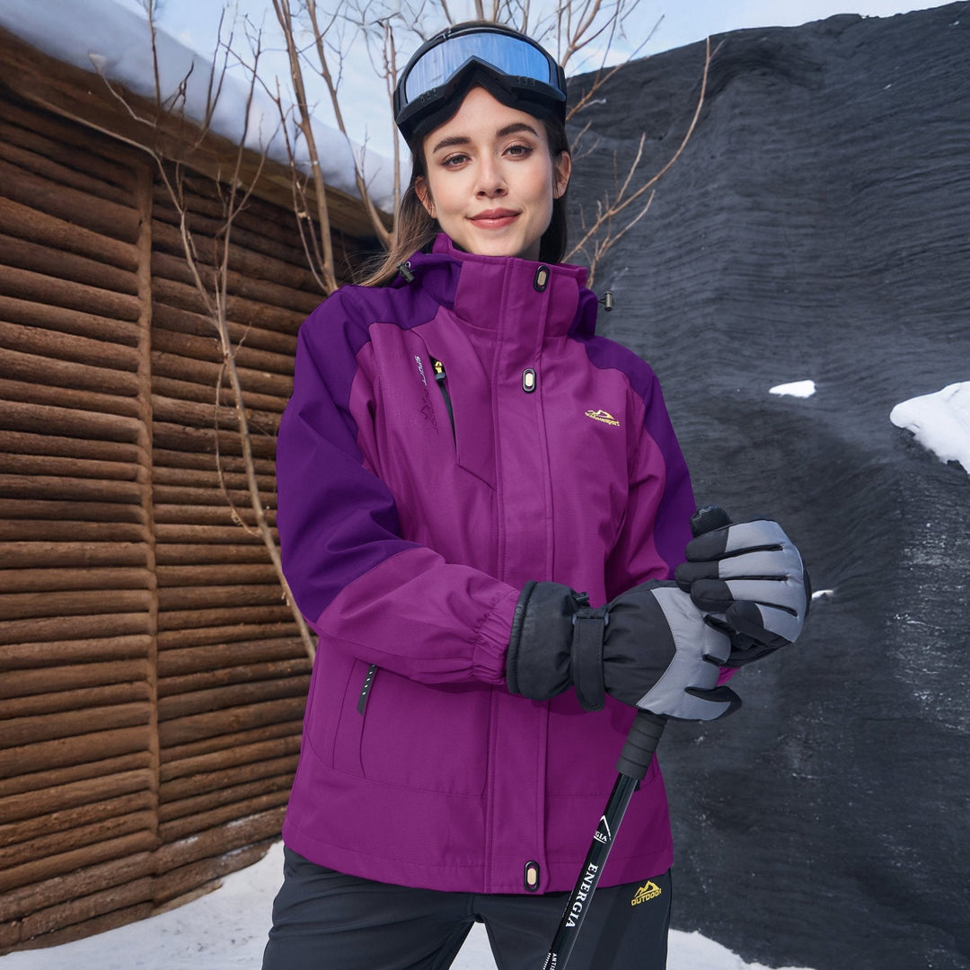 Woman standing near a lake, protected by her Verona 3-in-1 waterproof jacket, a true outdoor coat.