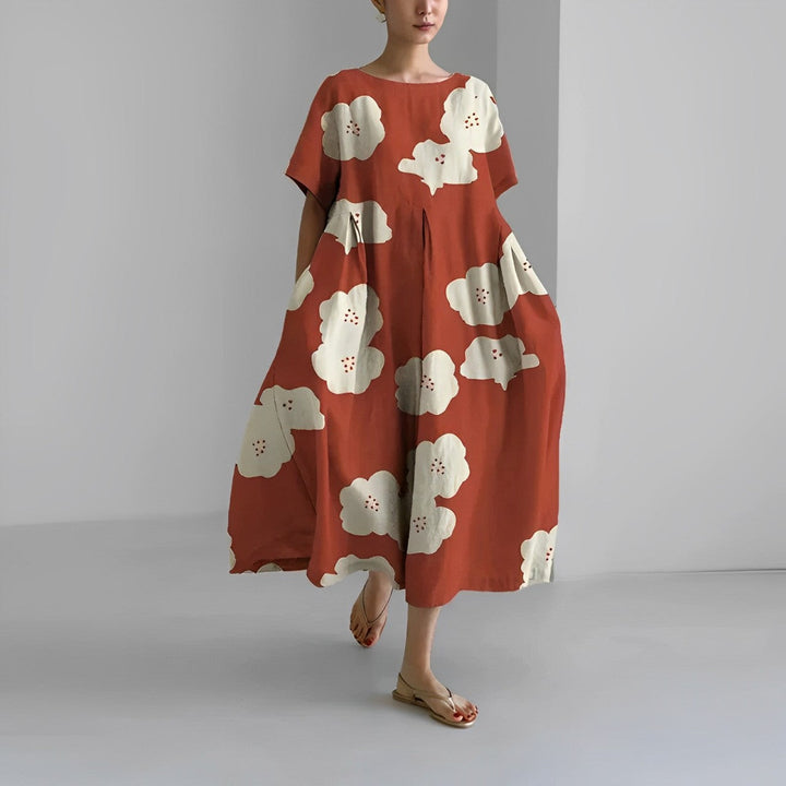 Women's vibrant floral maxi dress styled with summer accessories for comfortable casual wear.