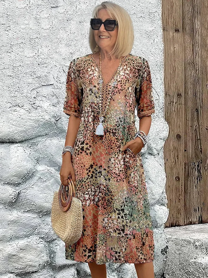 Elegant women's vibrant print midi dress, a flowy sleeveless design for comfortable summer party wear.