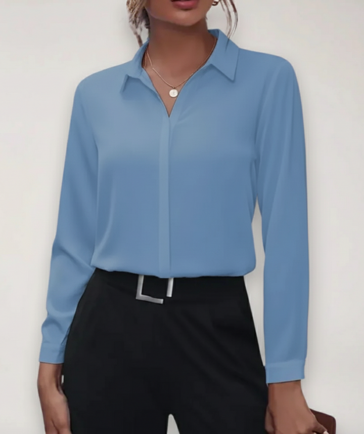 Crisp white long-sleeve buttoned blouse, a sophisticated women's top for office and spring.