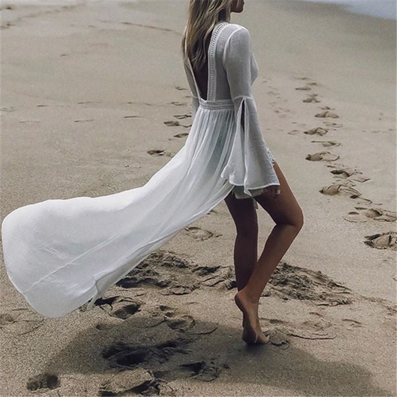 White maxi dress for women, perfect for summer vacation. Boasts an open back, elegant flare sleeves, and flowy fabric.