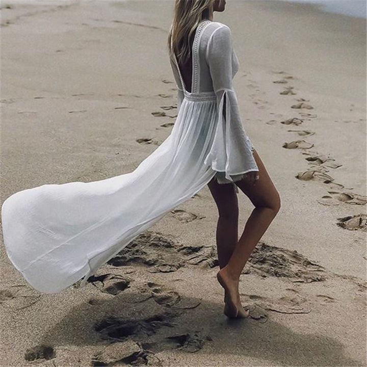 White maxi dress for women, perfect for summer vacation. Boasts an open back, elegant flare sleeves, and flowy fabric.