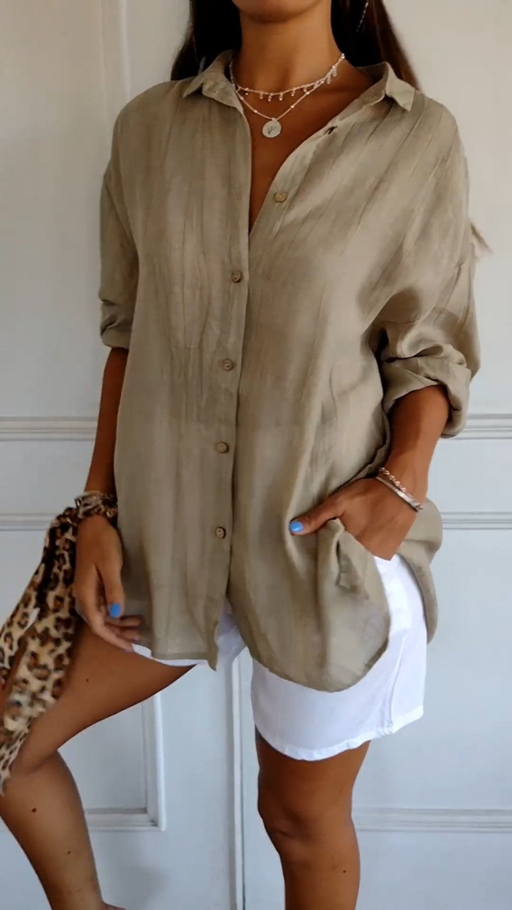 Stylish women's blue oversized button-down top. Collared, long sleeve, perfect for versatile summer fashion.