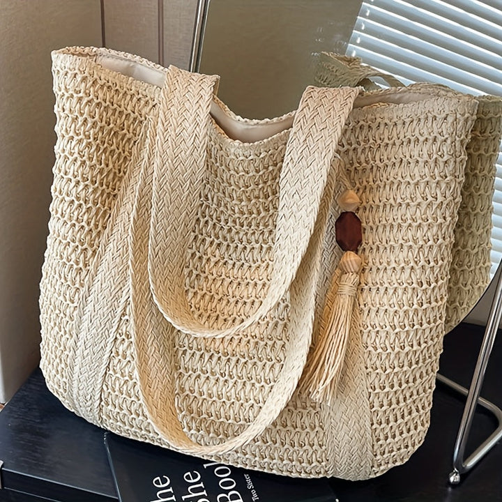 Handcrafted woven straw tote bag with fringe accents & stylish tassel. Ideal women's summer handbag.