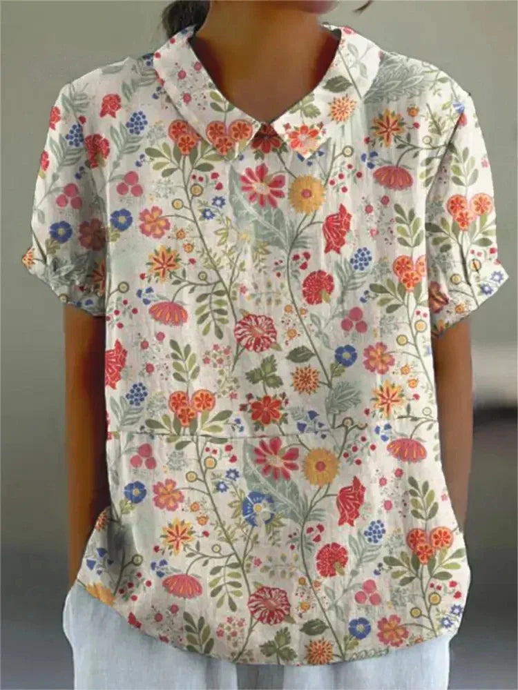 Women's blouse with short gathered sleeves, pointed collar, relaxed fit, perfect for spring-summer style and comfort.