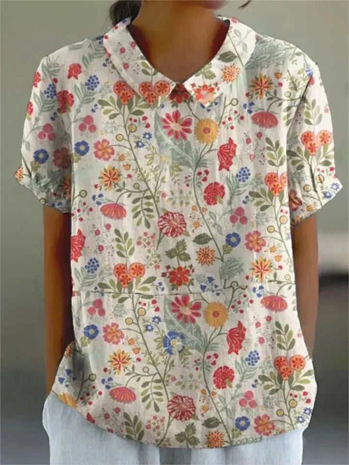 Women's blouse with short gathered sleeves, pointed collar, relaxed fit, perfect for spring-summer style and comfort.