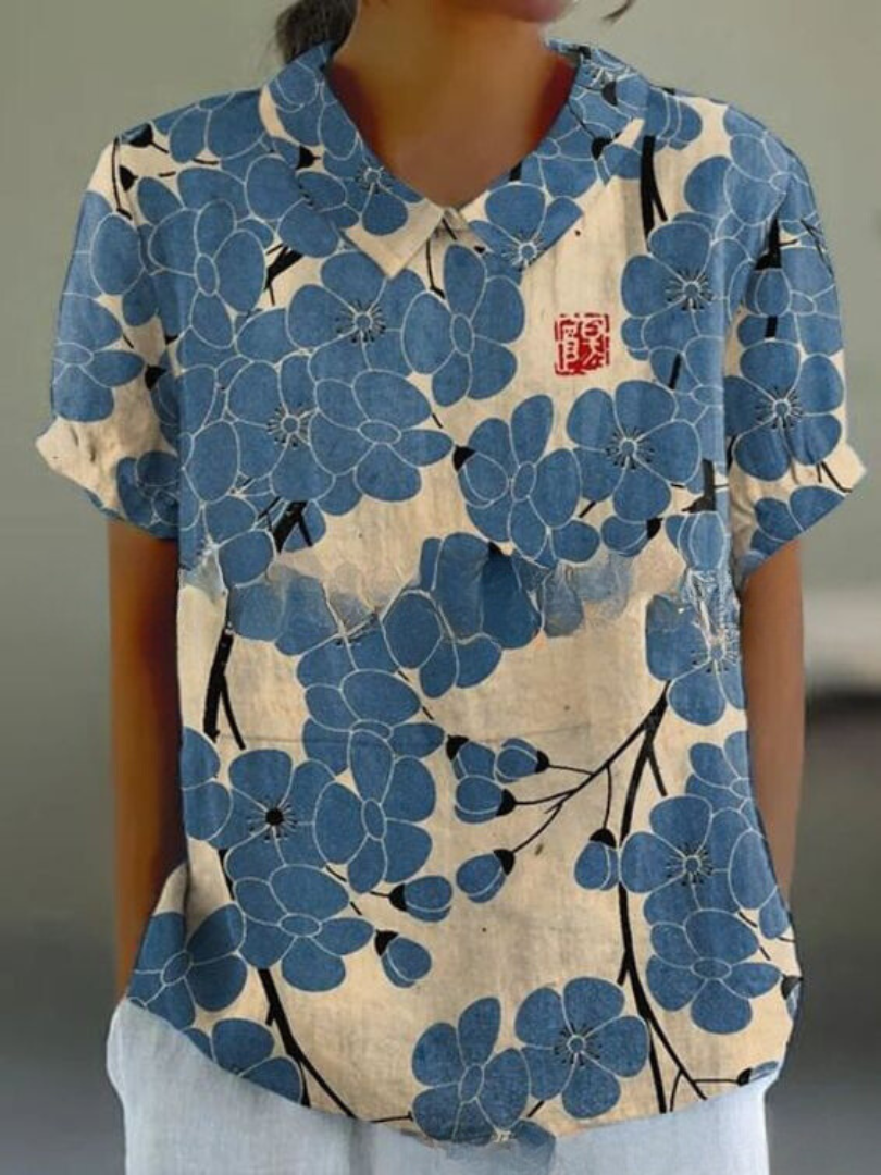 Women's blouse with short gathered sleeves, pointed collar, relaxed fit, perfect for spring-summer style and comfort.