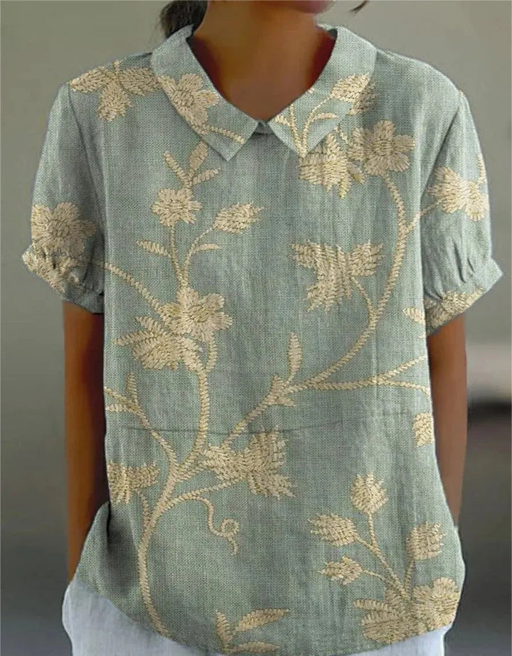 Women's blouse with short gathered sleeves, pointed collar, relaxed fit, perfect for spring-summer style and comfort.