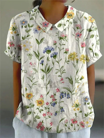 Women's blouse with short gathered sleeves, pointed collar, relaxed fit, perfect for spring-summer style and comfort.