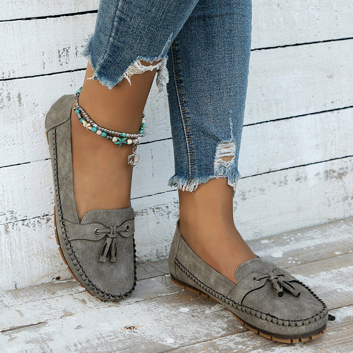 "Women's classic bow loafers in soft suede, stylish flat slip-ons with elegant bow accent, ideal for any occasion."