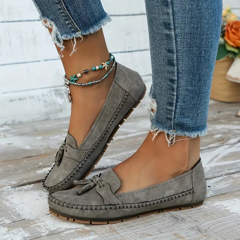 "Women's classic bow loafers in soft suede, stylish flat slip-ons with elegant bow accent, ideal for any occasion."