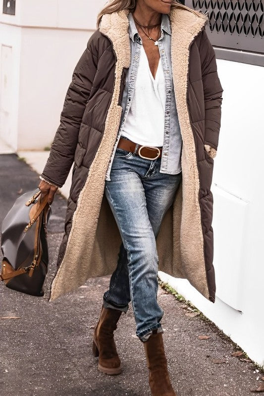 "Women's hooded longline quilted winter coat, front view; insulated, open front design with quilted texture and hood."