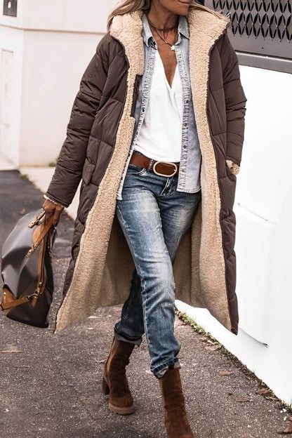 "Women's hooded longline quilted winter coat, front view; insulated, open front design with quilted texture and hood."