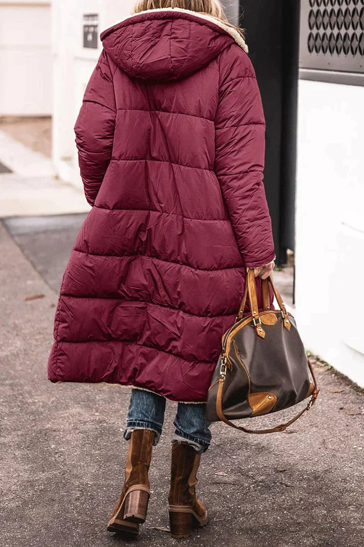 "Women's hooded longline quilted winter coat, front view; insulated, open front design with quilted texture and hood."