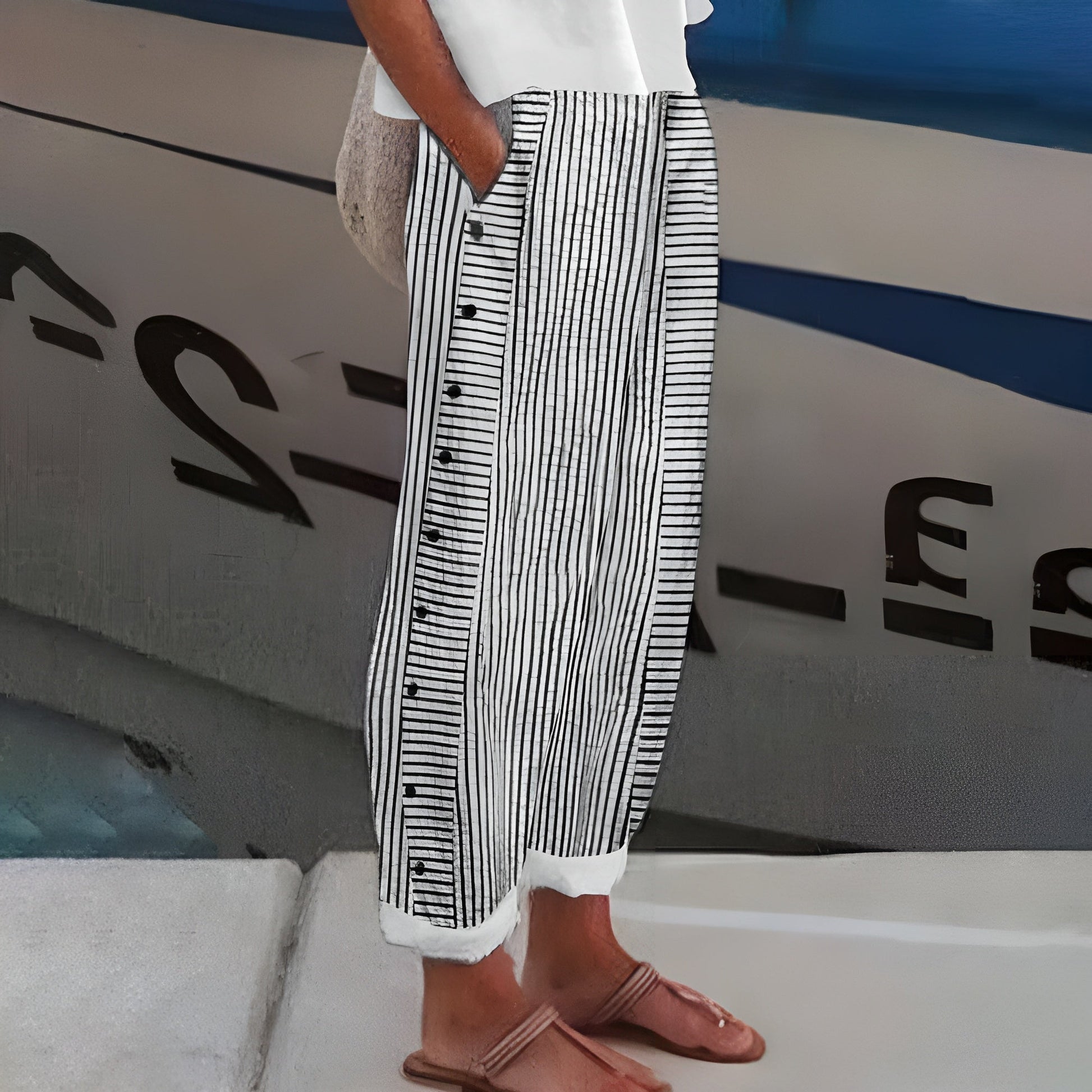 Women's linen blend striped pants, front view; drawstring waist, vertical stripes, ankle-length, side pockets, loose fit.