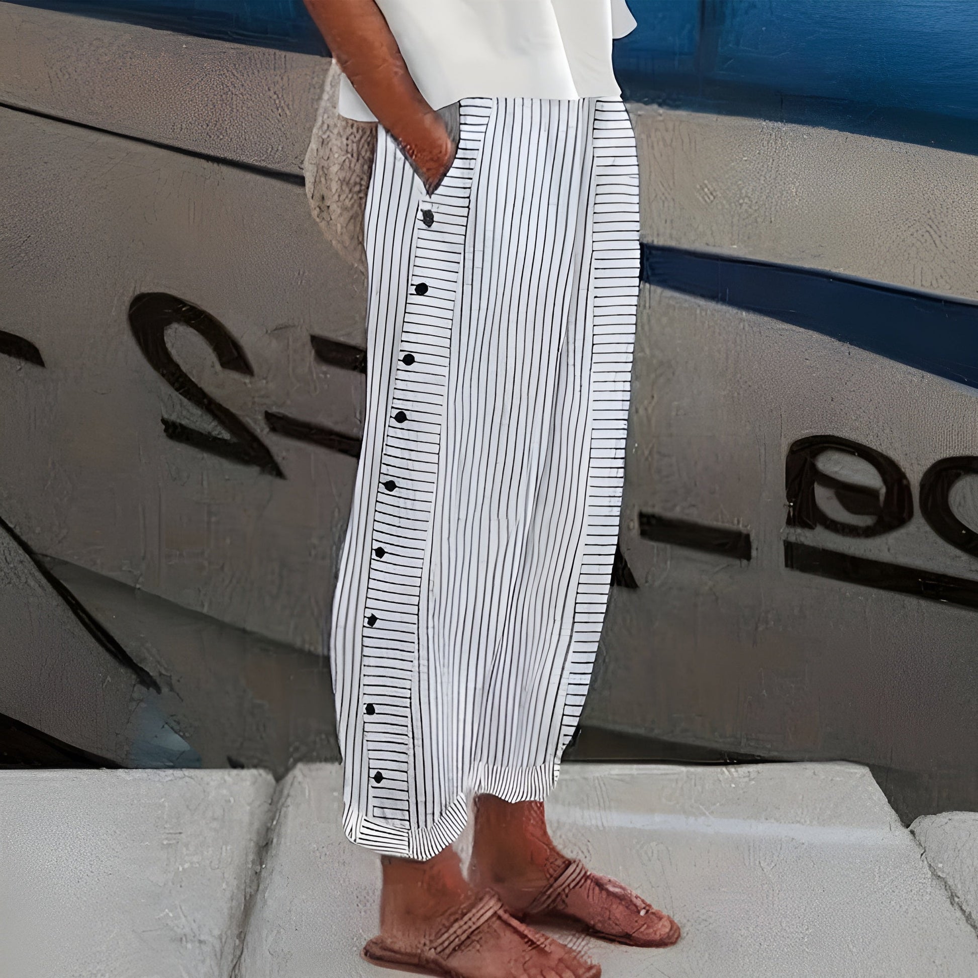 Women's linen blend striped pants, front view; drawstring waist, vertical stripes, ankle-length, side pockets, loose fit.