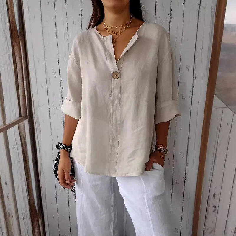 "Women's linen V-neck blouse with rolled sleeves, featuring a relaxed fit and soft breathable fabric."