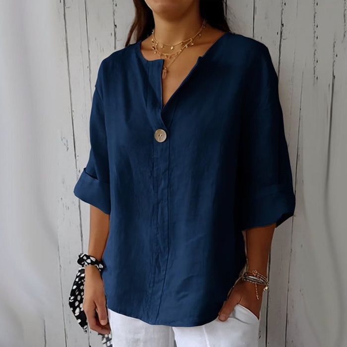 "Women's linen V-neck blouse with rolled sleeves, featuring a relaxed fit and soft breathable fabric."