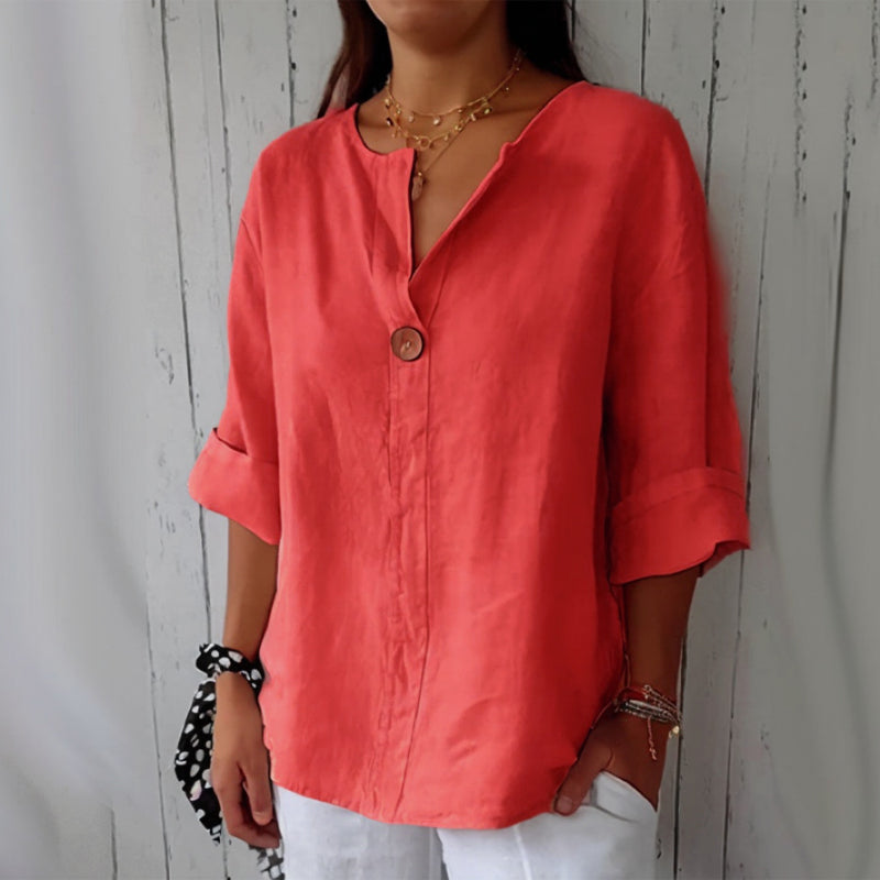 "Women's linen V-neck blouse with rolled sleeves, featuring a relaxed fit and soft breathable fabric."