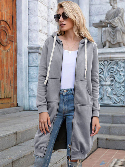Women's longline zip hoodie with drawstring hood, midweight fabric, extended length, cozy style for cooler seasons.